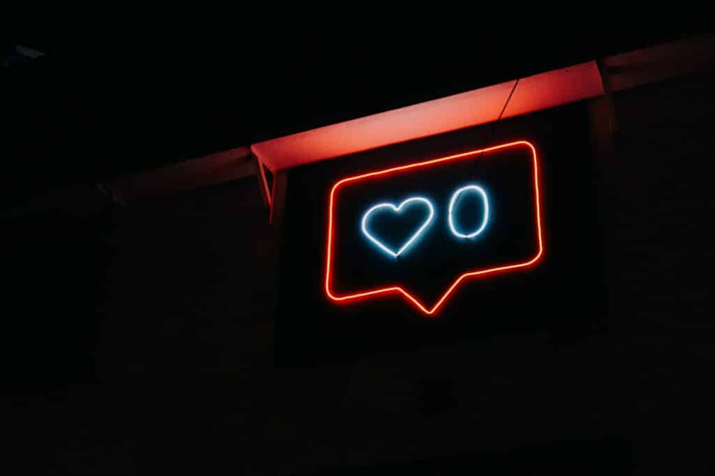 dark background neon sign at night shaped like an instagram like buble